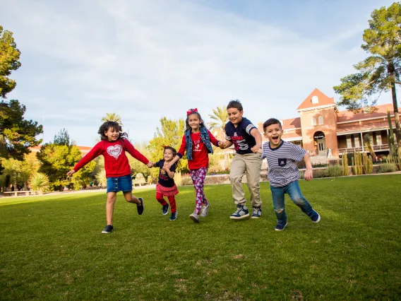 children playing out on the grass in front of Old Main